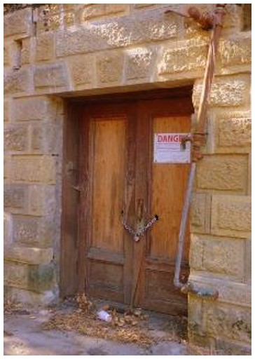 Before: front entrance of former hospital at grade and location of new entrance